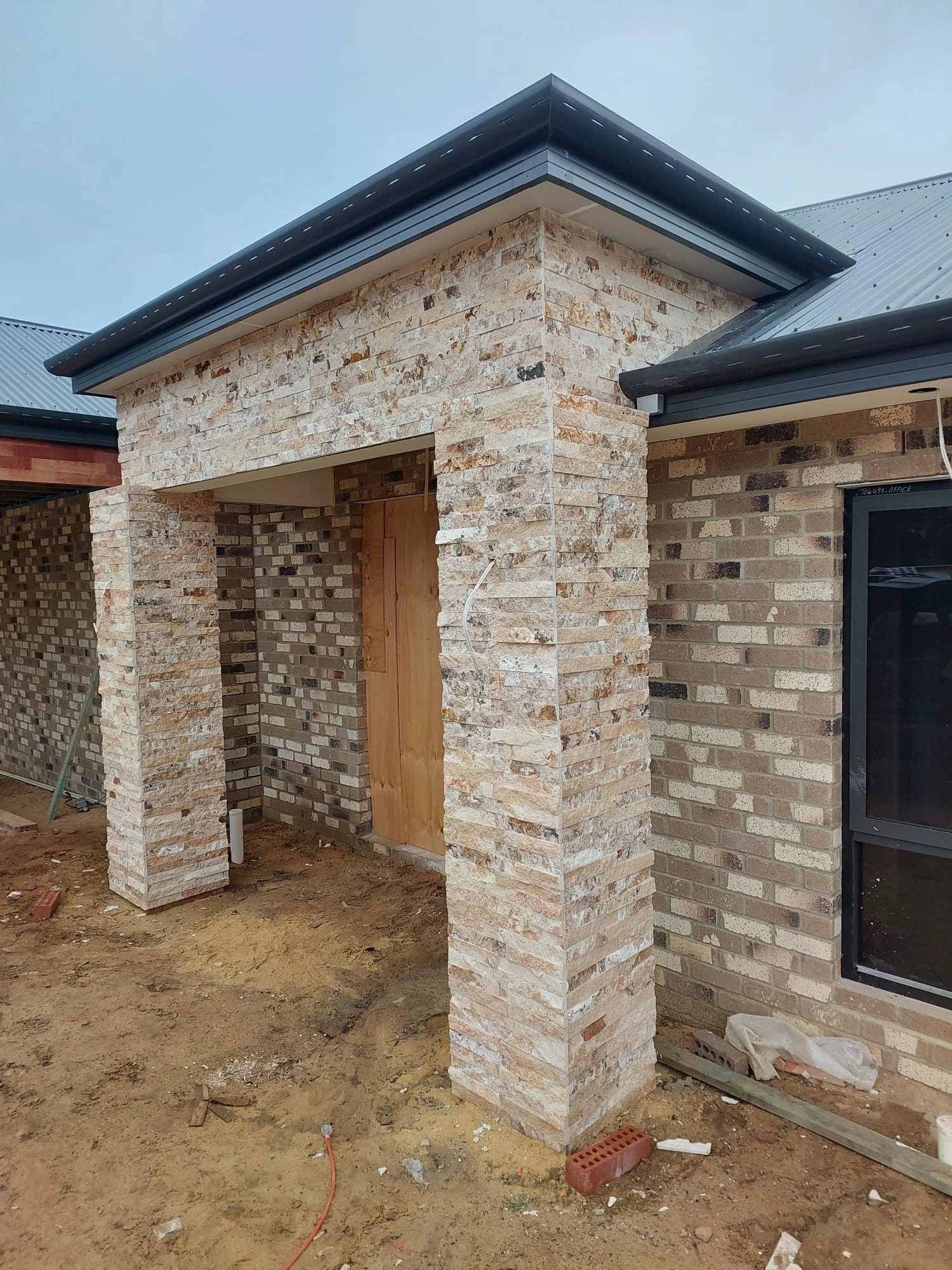 Natural-stone cladding around a residential exterior entrance